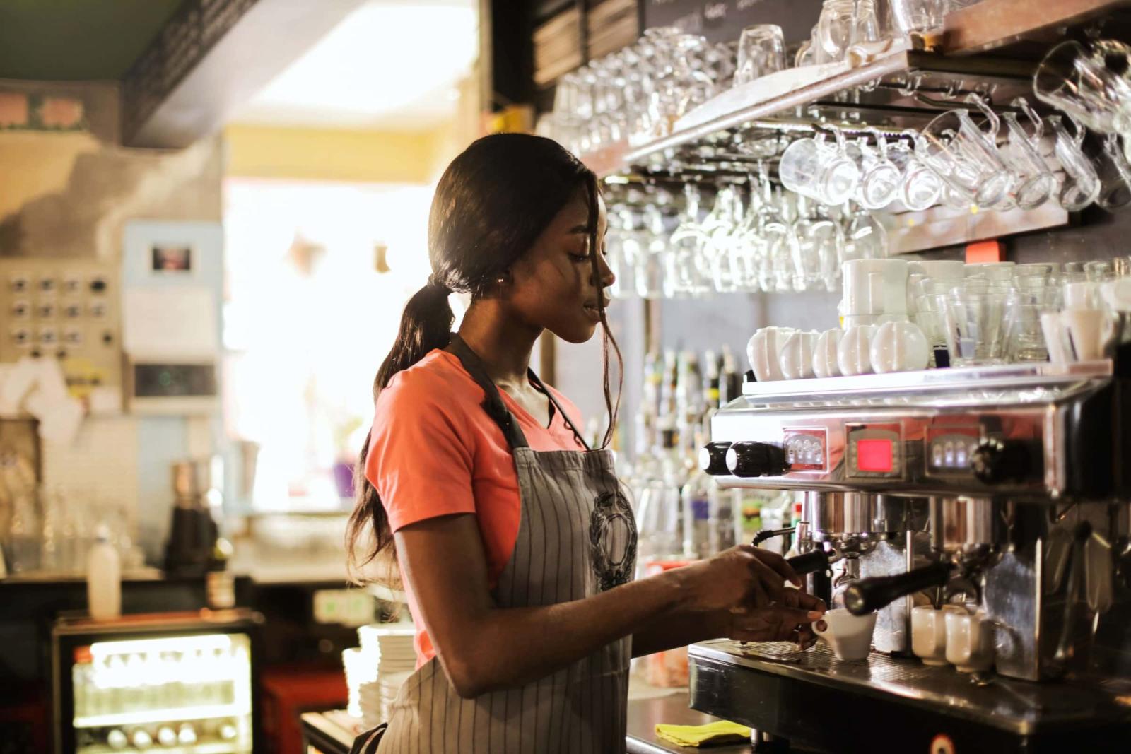 A part-time employee makes coffee on her scheduled shift